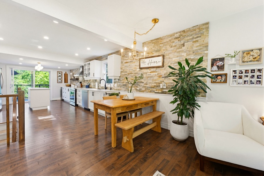 Open kitchen and dining area with stone feature wall